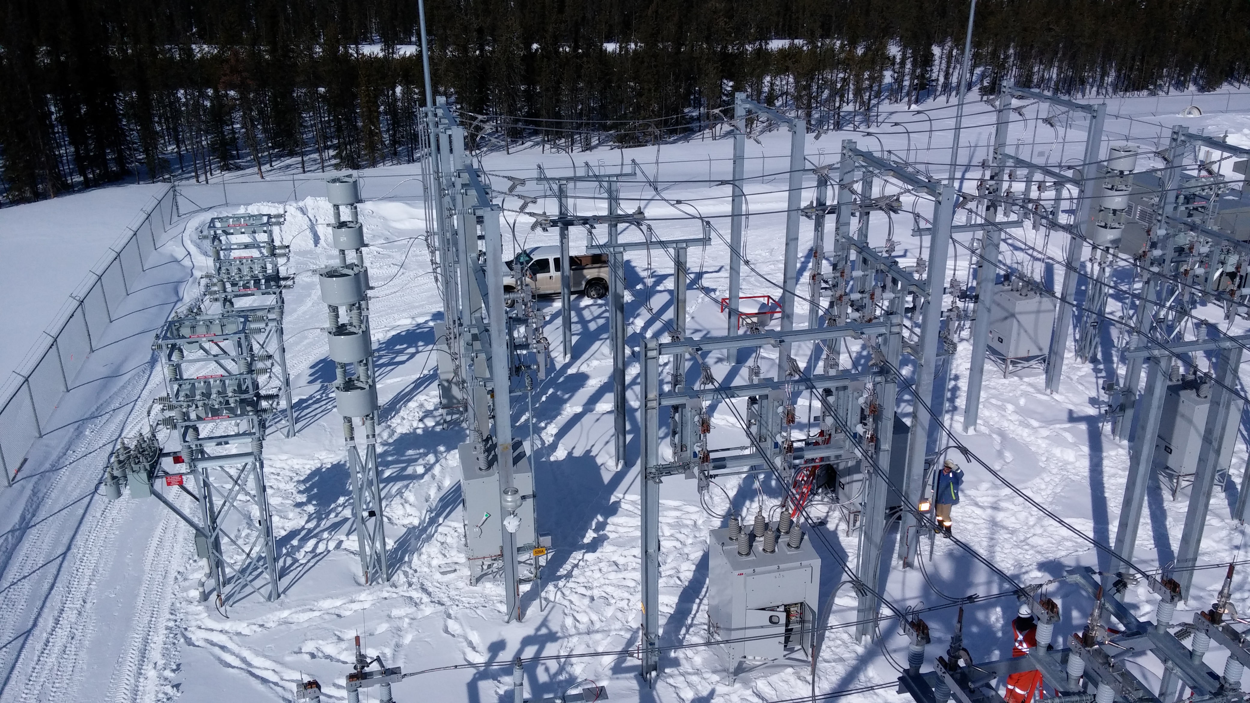 Substation lined with snow in a well treed area that was built by Dynamo